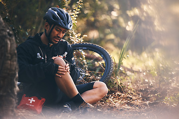 Image showing Man, cycling and outdoor with leg or knee injury in nature for sports, exercise or training on mountain bike. Athlete person with bicycle and first aid for fitness workout accident or fall in forest