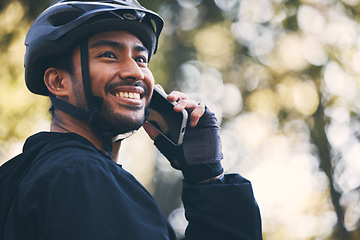 Image showing Man, cycling and phone call outdoor in nature for sports, exercise or training on a mountain bike. Athlete male person on a smartphone for communication with contact for a fitness workout in a forest