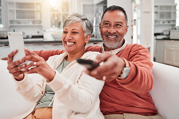 Image showing Watching tv, phone and happy couple in home living room, bonding and having fun. Cellphone, television and elderly man and woman enjoying retirement, smile and streaming movie, video or film on sofa.