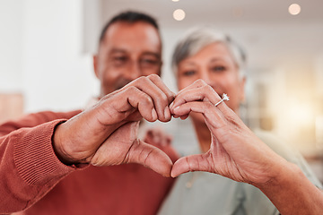 Image showing Couple, senior and heart hands in home, love and bonding in retirement together. Romance, hand gesture and elderly man and woman with emoji for care, affection and empathy, commitment and trust.