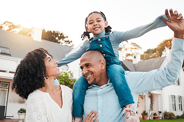 Image showing Happy, parents and carrying girl on shoulder relax in garden for bonding, quality time and playing outdoors. Love, family and dad with mom, child and kid smile on summer vacation, weekend and freedom