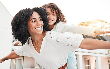 Image showing Happy, mother and carrying flying girl on back in home garden for family bonding, quality time or playing game outdoors. Love, airplane or mom piggyback child with smile on summer vacation or weekend