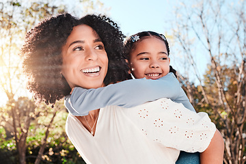 Image showing Family, mother and piggyback child in outdoor love, care and playing games for fun in backyard. Smile of woman carrying girl kid in nature to relax together in summer with a hug for support or trust