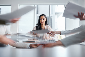 Image showing Business woman, anxiety and stress in a meeting or busy office with documents or paperwork. Professional female manager at table with team hands for stress, depression or burnout for deadline crisis