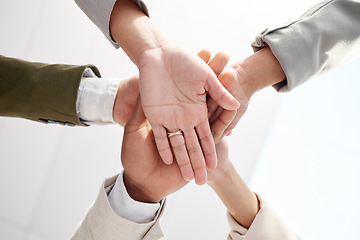 Image showing Business people, hands together and solidarity with team support, low angle and motivation in office. Success, collaboration and corporate group with teamwork, professional community and workforce