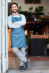 Image showing Happy, arms crossed and portrait of an Asian man at a restaurant for a welcome, service and job at the door. Smile, working and a Japanese waiter at entrance of a cafe of coffee shop in the morning