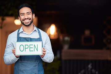 Image showing Happy asian man, small business and open sign for service in coffee shop or restaurant. Portrait of male entrepreneur, manager or waiter holding billboard or poster for opening retail store or cafe