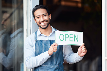 Image showing Happy asian man, small business and portrait with open sign for service in coffee shop or restaurant. Male entrepreneur, manager or waiter holding billboard or poster for opening retail store or cafe