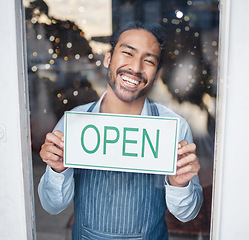 Image showing Asian man, small business and face with open sign on window for service in coffee shop or restaurant. Portrait of happy male entrepreneur holding billboard or poster for opening, retail store or cafe