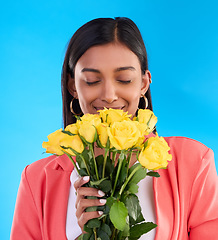 Image showing Scent, flowers and roses with woman in studio for gift, satisfaction and spring. Relax, happy and floral present with female and bouquet isolated on blue background for aroma, natural and products