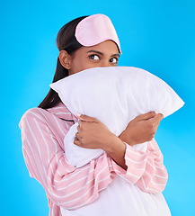 Image showing Comfy, bedtime and a woman hugging a pillow isolated on a blue background in a studio. Relax, rest and an Indian girl ready for sleep, napping or night rest and thinking of sleeping on a backdrop