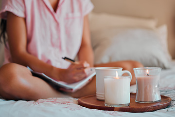 Image showing Notebook, writing and woman with home candles for healing journal, calm planning or self care inspiration in bedroom. Creative person or writer for mindfulness goals, meditation or peace notes in bed