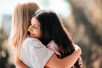 Image showing Woman friends, hug and reunion outdoor in park, garden or backyard with love, care and bonding in summer. Women, embrace and happiness for meeting, welcome and support in sunshine for solidarity