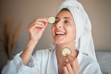 Image showing Happy woman, cucumber and natural skincare for beauty, cosmetics or facial treatment at spa. Female smiling and applying vegetable to eyes for organic healthcare, hydration or dermatology at salon