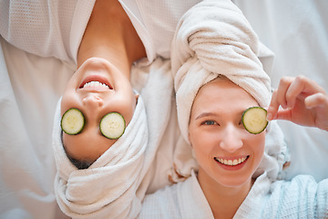 Image showing Friends, face and teenager, girl and facial, pampering and beauty, cucumber in portrait for skincare treatment. Happiness, people have fun together and female friendship, cosmetic care and top view