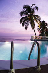 Image showing luxury infinity swimming pool caribbean sunset