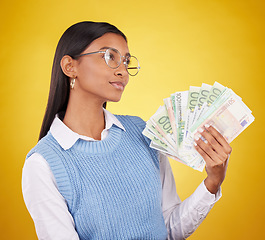 Image showing Young woman and money fan isolated on studio background of wealth, cash winning or financial freedom ideas. Rich and confident indian person or winner thinking of investing bonus, cashback or lottery
