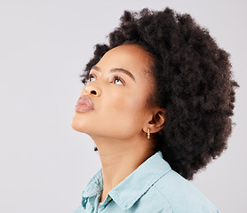 Image showing Black woman, afro and thinking in studio with vision, ideas or looking up by white background. Girl, young model and student with idea, brainstorming or mindset for focus, fashion or calm by backdrop