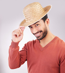 Image showing Happy, handsome and portrait of an Asian man with a hat isolated on a white background in studio. Smile, trendy and a guy wearing headwear made of straw with confidence and happiness on backdrop