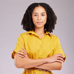 Image showing Serious, woman and portrait in studio, arms crossed and background for style, confidence and fashion. Focused female model in yellow dress with attitude, empowerment and pride of trendy personality