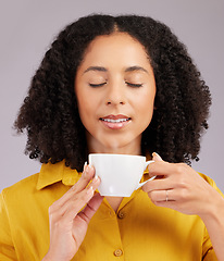 Image showing Relax, enjoying aroma and a woman drinking coffee isolated on a white background in studio. Calm, content and a girl with a warm beverage or cup of tea for relaxation, peace or a break on a backdrop