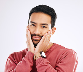 Image showing Portrait, shy and in love with a man in studio isolated on a white background while touching his cheeks. Face, coy and cute with a handsome young indian male feeling special on valentines day