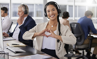 Image showing Hands, heart and portrait of happy woman in call center for customer care, excellence and sales support in office. Female consultant, gesture and love sign for telemarketing services, emoji and smile