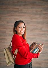 Image showing Portrait, books and education with a student woman on a wooden background for learning at college or university. School, study and scholarship with an attractive young female pupil wearing a backpack