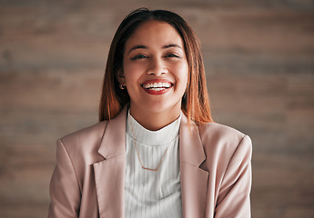 Image showing Portrait, happy and a business woman on a wooden background in studio with a positive mindset. Face, smile and motivation with a carefree young female employee feeling cheerful for a corporate career