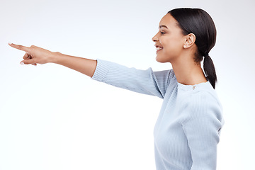 Image showing Studio, profile and happy model pointing at sales promotion, advertising copy space and discount deal mockup. Brand commercial, marketing and product placement gesture for woman on white background