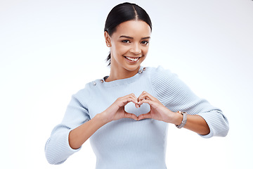 Image showing Portrait, heart and hand gesture with a woman on a white background isolated in studio for health or love. Face, hands and emoji with an attractive young female indoor for romance or valentines day