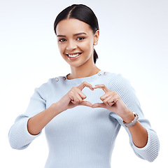 Image showing Face portrait, studio and happy woman with heart hand sign for romantic love, care and support. Valentines day, happiness and isolated person with emoji icon gesture for kindness on white background