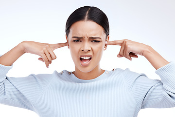 Image showing Portrait, woman and finger in ears for noise, silence and denial gesture on studio white background. Omg, face and angry girl with complaint, ignoring and deaf, wtf and emoji, frustrated and annoyed