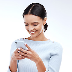 Image showing Phone, typing and happy woman isolated on a white background for social media, funny meme or internet chat. Young person networking, communication or reading news or post on mobile app in studio