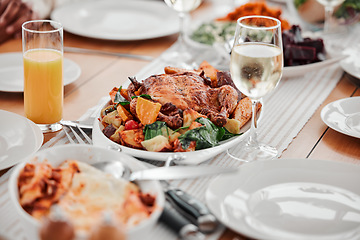 Image showing Food, dinner and party with drinks and table setting, celebration and holiday with Christmas or thanksgiving. Social event, gathering and wine, chicken and juice with gourmet meal, festive and feast