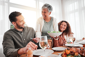 Image showing Family, dinner and party, happy while eating together with love and food, celebration and holiday. Man with women at social gathering, relationship and hungry people with meal, happiness and carefree