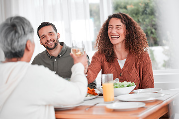 Image showing Family dinner, couple and cheers of a happy woman with healthy food in a home. Celebration, together and people with unity from eating at table with happiness and a smile in a house with toast