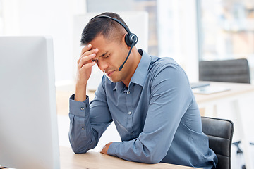 Image showing Headache, migraine pain or man in call center with burnout feeling overworked in crm communication. Stressed, office or tired telemarketing sales agent with anxiety, fatigue or mental health problems