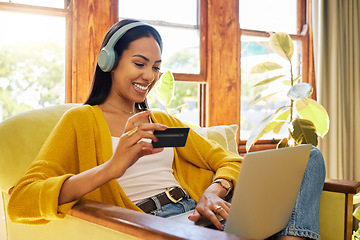 Image showing Woman, laptop and credit card with ecommerce and headphones to listen to music while online shopping. Happy female relax at home, podcast or radio streaming with fintech, internet banking and payment