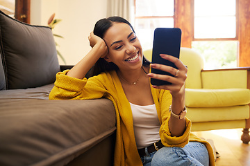 Image showing Smile, relax and a woman with a phone for an app, communication and social media. Happy, funny and a girl reading a text message, chat or notification on a mobile in the living room of a house