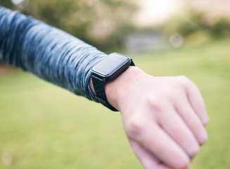 Image showing Smart watch, closeup person and fitness outdoor at park, exercise and running in nature. Stopwatch, hands and runner check time, heart rate and monitor healthy training progress, clock or sports gear