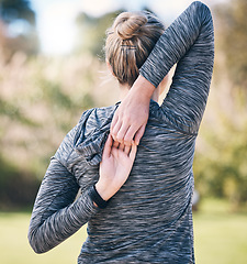 Image showing Back of woman, fitness and stretching arms for exercise, training and sports in park. Female athlete warm up for workout, performance and energy outdoors in nature, wellness and runner commitment