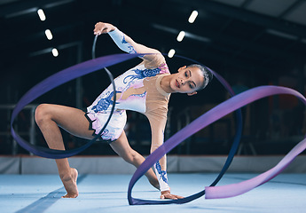 Image showing Ribbon, gymnastics and woman dancer in performance, action and sports competition. Female, rhythmic movement and flexible dancing athlete, creative skill and talent of concert event in practice arena