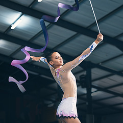 Image showing Ribbon gymnastics, woman and dancing in performance, training show and sports competition. Young female, rhythmic movement and elegant dancer in action, creative talent and energy for concert event