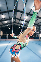 Image showing Woman, gymnastics and hoop for competition, sports training and dancing action in arena. Female, rhythmic movement and dancer with spinning ring for creative talent, solo concert or event performance