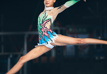 Image showing Gymnastics, fitness and zoom on woman jumping in arena for competition, exercise and training with mockup space. Sports, movement and jump, professional gymnast with form and balance in performance.