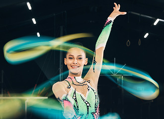 Image showing Ribbon gymnastics, happy woman and portrait of motion, dancing performance and competition in dark arena. Female dancer, rhythmic movement and solo routine of creative talent, sports concert or smile