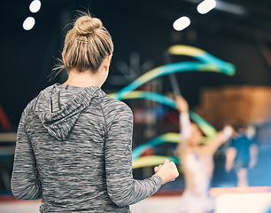 Image showing Coaching, gymnastics and cheering with woman in stadium for training, fitness and teaching. Celebration, sports and workout practice with coach and acrobat for performance, flexibility and show