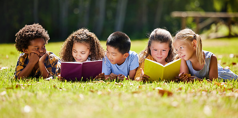 Image showing Children, books and lying in park with friends, learning or diversity for reading at school playground. Kids, education or study with support, mockup space or solidarity at multicultural kindergarten