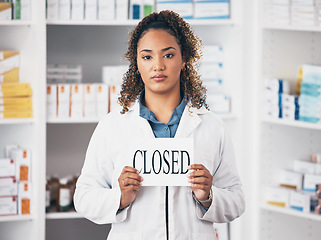 Image showing Portrait, woman and closed sign of store, pharmacy and shop in recession, bankruptcy and economy. Serious female pharmacist advertising retail closing with poster, board and announcement in drugstore